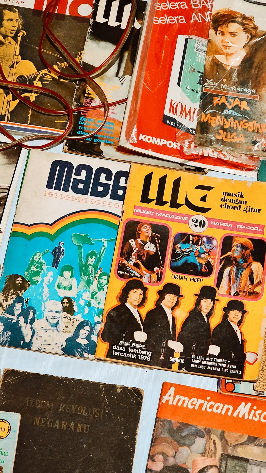 Stack of vintage glossy magazine covers arranged on a table