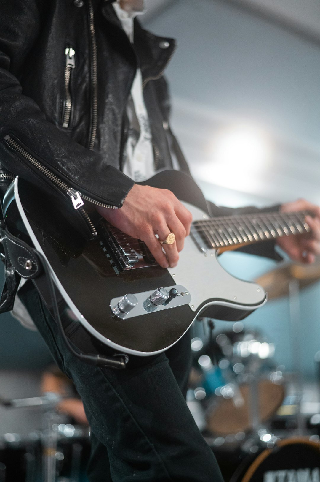 musician playing guitar on stage